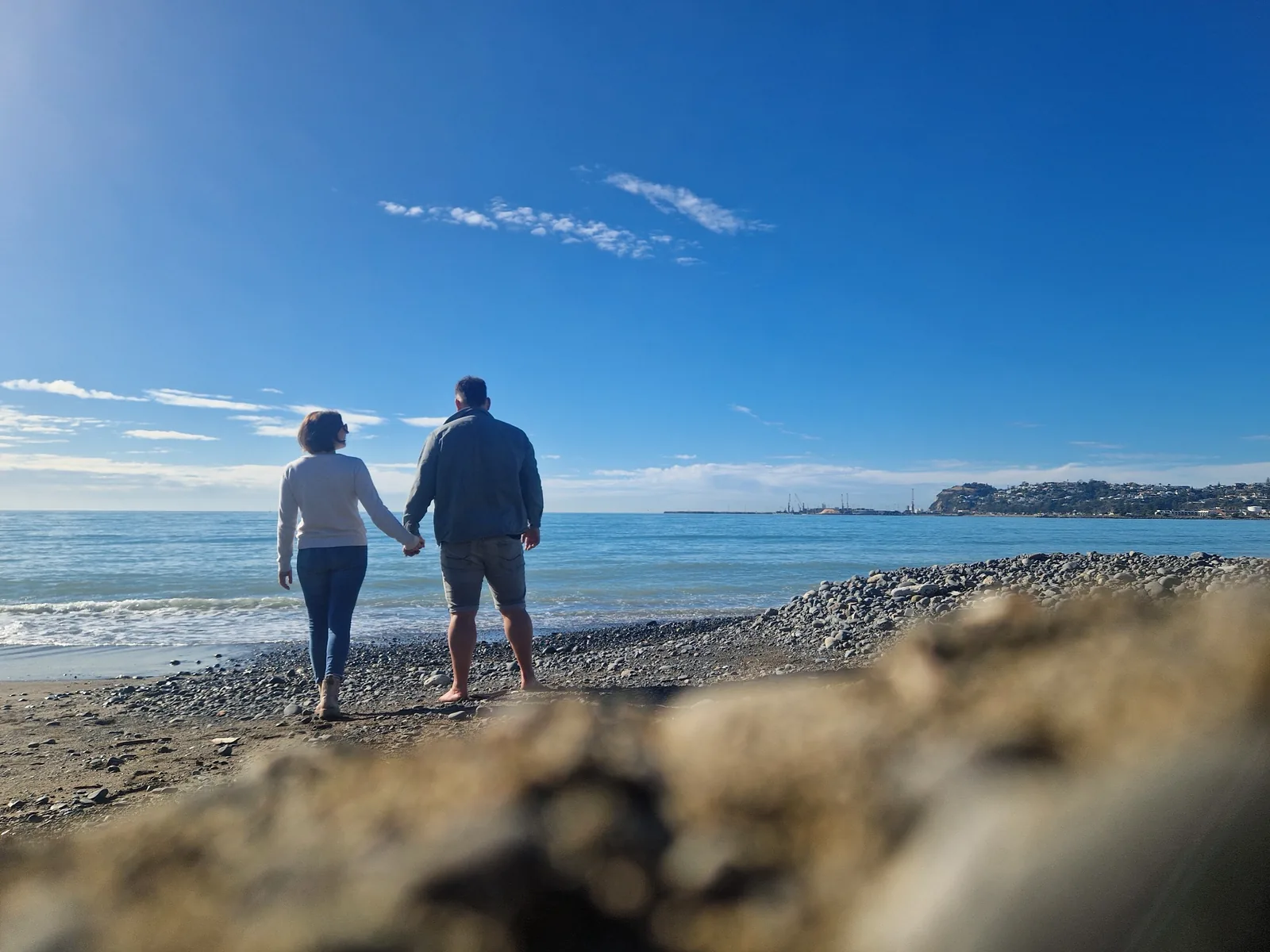 Walking hand in hand beside the sea